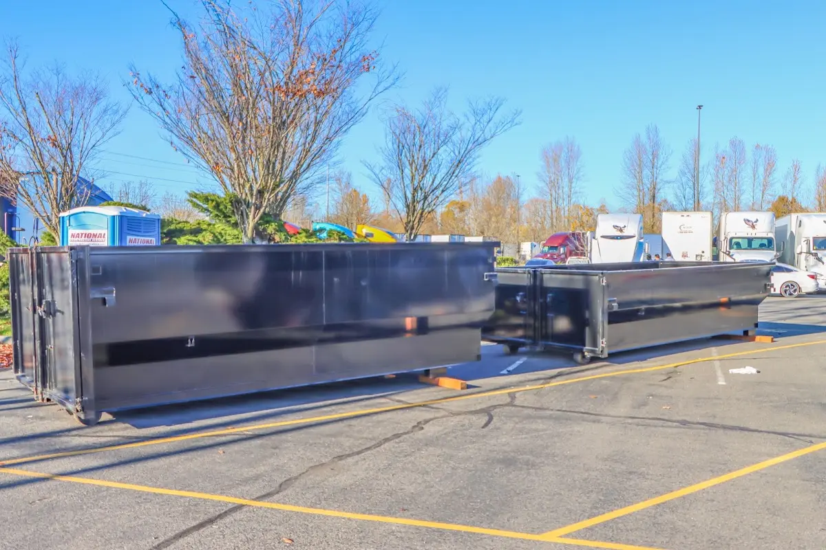 Professional dumpster rental service with roll-off container on residential driveway in Waupun